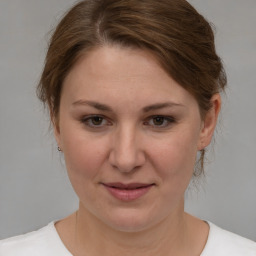 Joyful white adult female with medium  brown hair and brown eyes