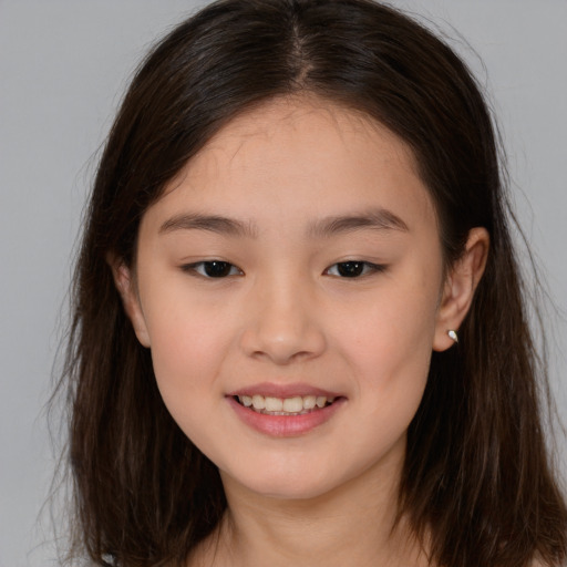 Joyful white child female with long  brown hair and brown eyes