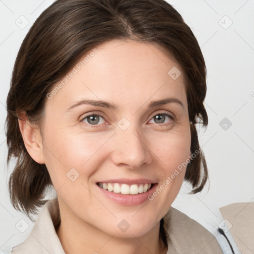 Joyful white young-adult female with medium  brown hair and grey eyes