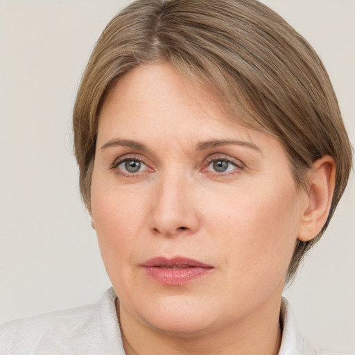 Joyful white adult female with medium  brown hair and brown eyes