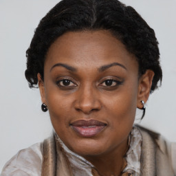 Joyful black adult female with short  brown hair and brown eyes