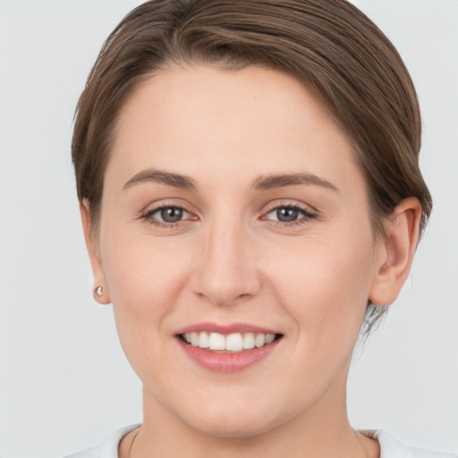 Joyful white young-adult female with short  brown hair and brown eyes