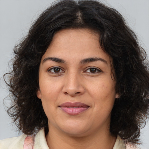 Joyful white adult female with medium  brown hair and brown eyes