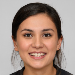 Joyful white young-adult female with medium  brown hair and brown eyes