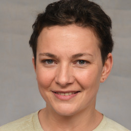 Joyful white adult female with short  brown hair and grey eyes