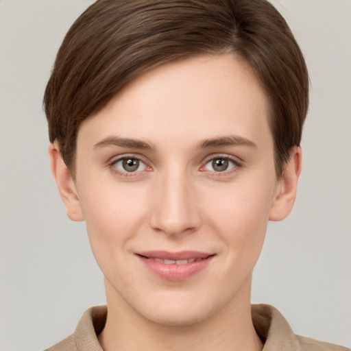 Joyful white young-adult female with short  brown hair and grey eyes