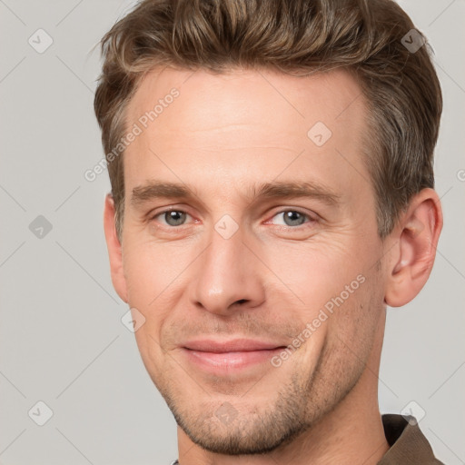 Joyful white adult male with short  brown hair and grey eyes