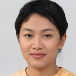 Joyful asian young-adult female with medium  brown hair and brown eyes