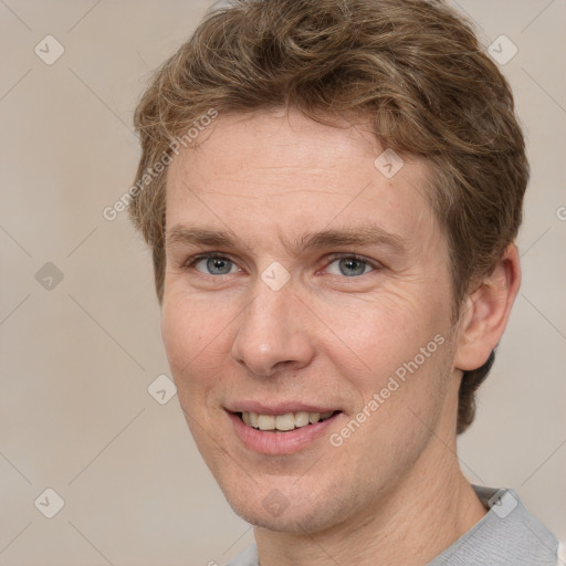 Joyful white adult male with short  brown hair and grey eyes