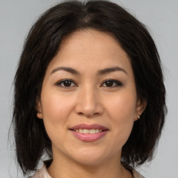 Joyful asian young-adult female with medium  brown hair and brown eyes