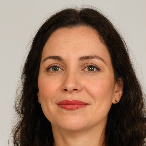 Joyful white adult female with long  brown hair and brown eyes