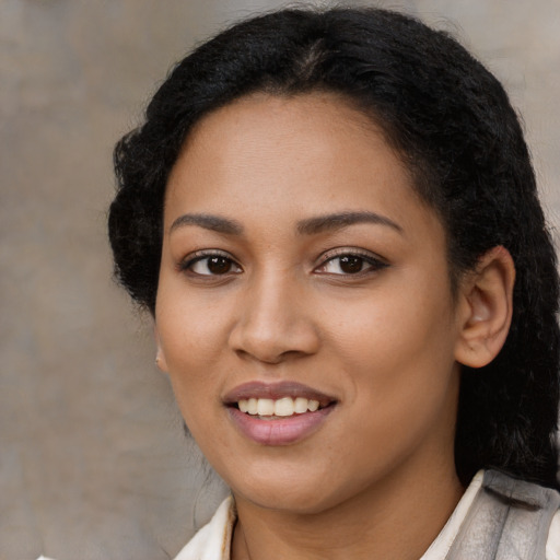 Joyful latino young-adult female with medium  black hair and brown eyes