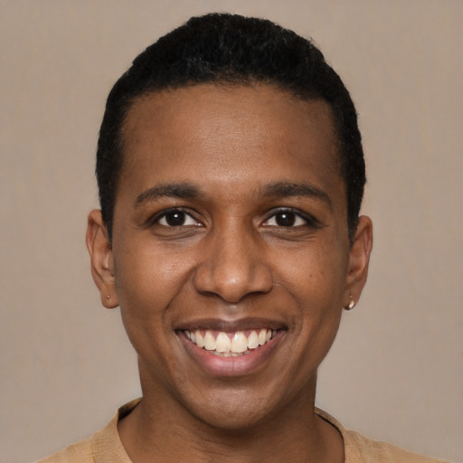 Joyful black young-adult male with short  black hair and brown eyes