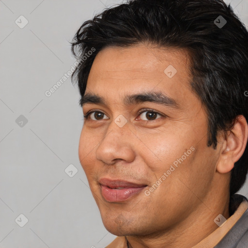 Joyful white adult male with short  black hair and brown eyes