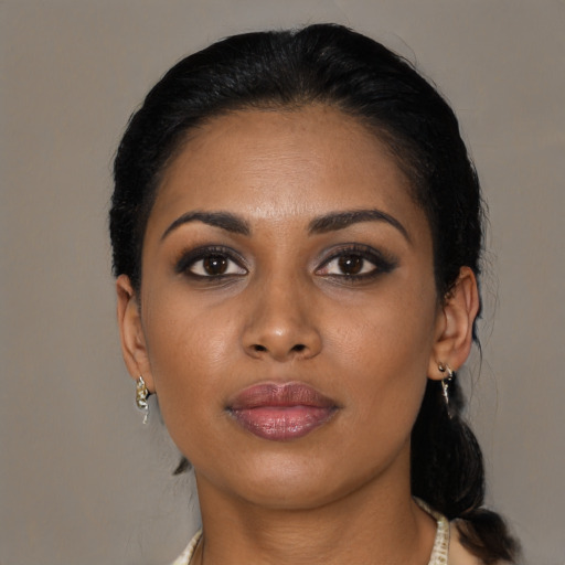 Joyful black young-adult female with medium  black hair and brown eyes