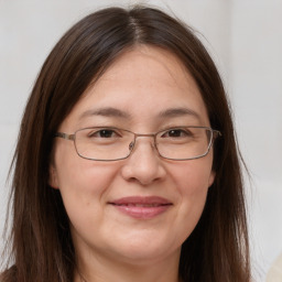 Joyful white adult female with long  brown hair and brown eyes