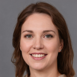 Joyful white young-adult female with medium  brown hair and green eyes