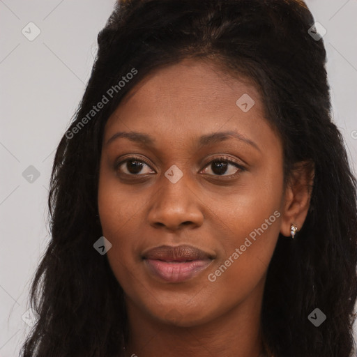 Joyful black young-adult female with long  brown hair and brown eyes