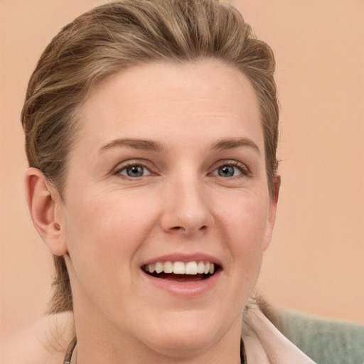 Joyful white young-adult female with short  brown hair and grey eyes