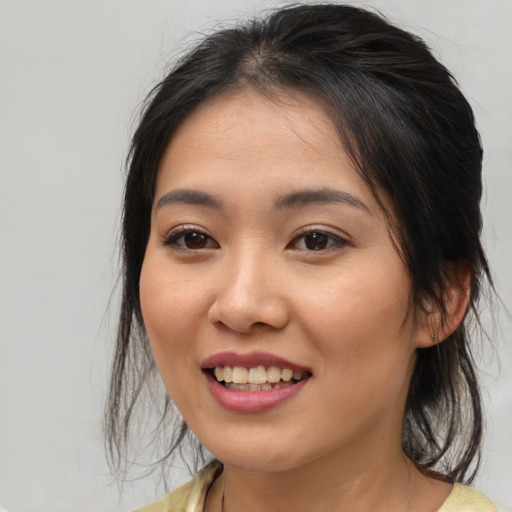 Joyful white young-adult female with medium  brown hair and brown eyes