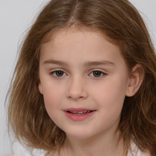 Joyful white child female with medium  brown hair and brown eyes