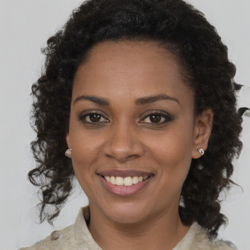 Joyful black young-adult female with medium  brown hair and brown eyes