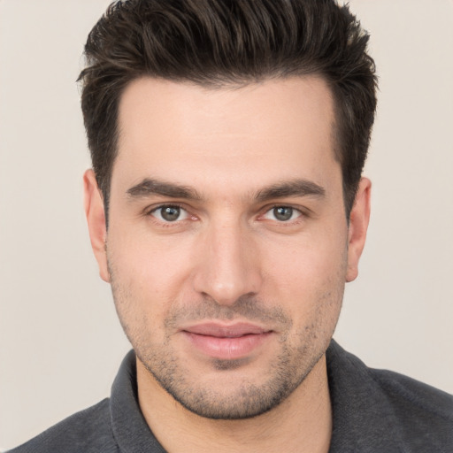 Joyful white young-adult male with short  brown hair and brown eyes