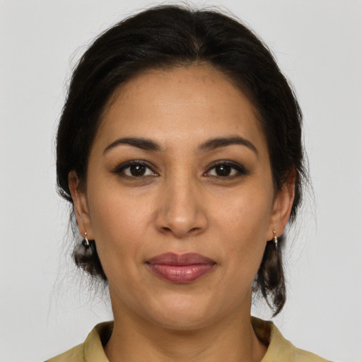 Joyful latino young-adult female with medium  brown hair and brown eyes