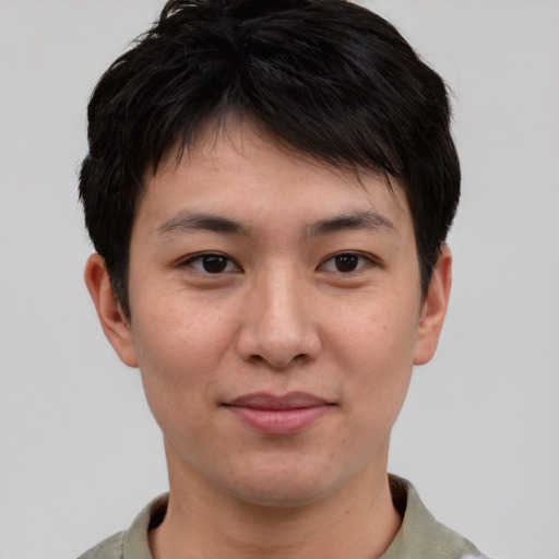 Joyful asian young-adult male with short  brown hair and brown eyes