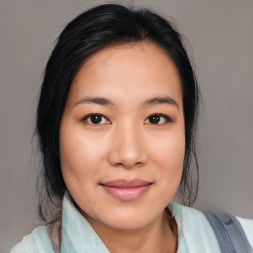 Joyful asian young-adult female with medium  black hair and brown eyes