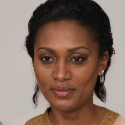 Joyful black adult female with medium  brown hair and brown eyes