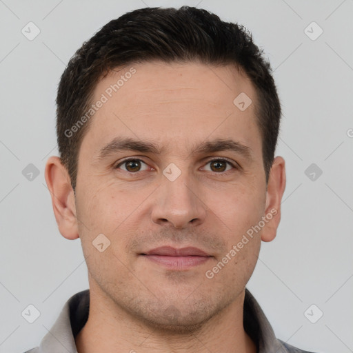 Joyful white young-adult male with short  brown hair and brown eyes