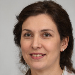 Joyful white adult female with medium  brown hair and brown eyes