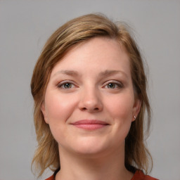 Joyful white young-adult female with medium  brown hair and blue eyes