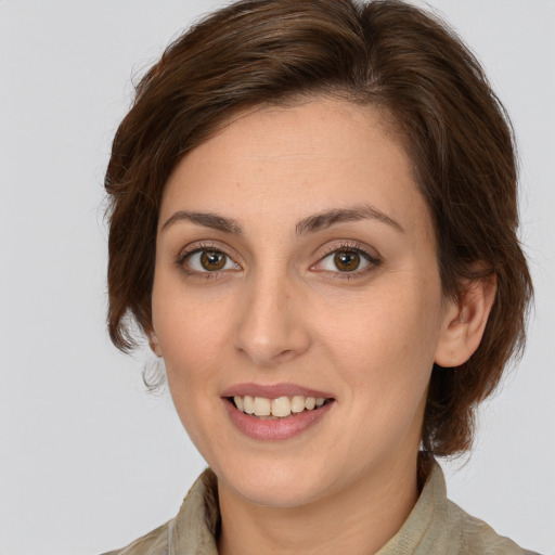 Joyful white young-adult female with medium  brown hair and green eyes