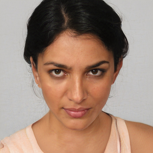 Joyful white young-adult female with medium  black hair and brown eyes
