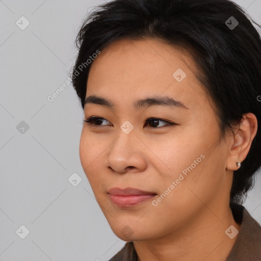 Joyful asian young-adult female with medium  black hair and brown eyes