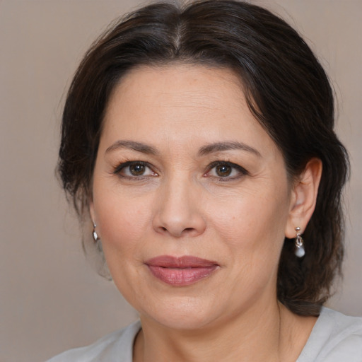 Joyful white adult female with medium  brown hair and brown eyes