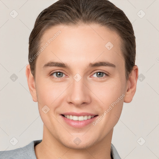 Joyful white young-adult male with short  brown hair and grey eyes