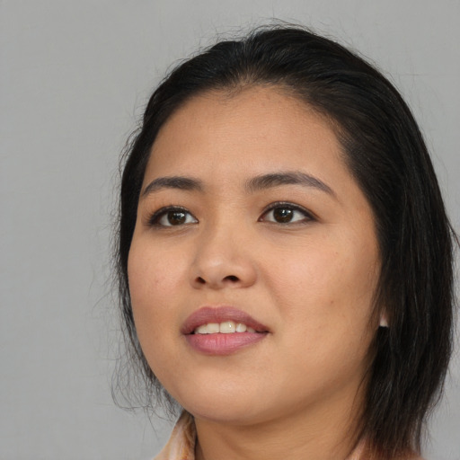 Joyful asian young-adult female with long  black hair and brown eyes