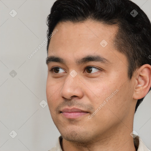 Joyful white young-adult male with short  black hair and brown eyes