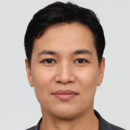 Joyful asian young-adult male with short  black hair and brown eyes