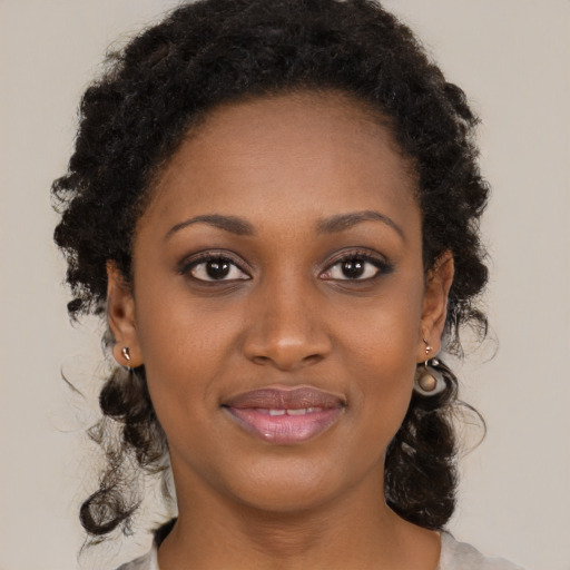 Joyful black young-adult female with medium  brown hair and brown eyes