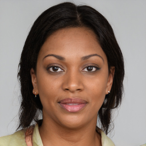 Joyful black young-adult female with medium  brown hair and brown eyes