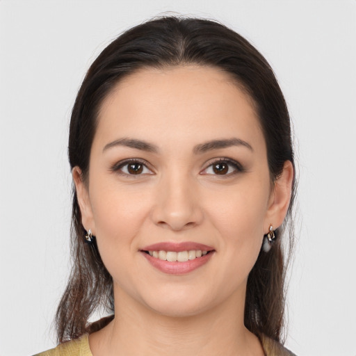 Joyful white young-adult female with long  brown hair and brown eyes