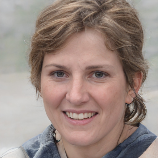 Joyful white young-adult female with medium  brown hair and blue eyes