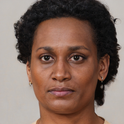 Neutral black adult female with short  black hair and brown eyes