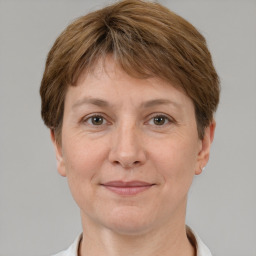 Joyful white adult female with short  brown hair and brown eyes