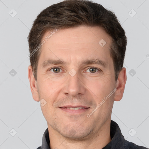 Joyful white adult male with short  brown hair and brown eyes