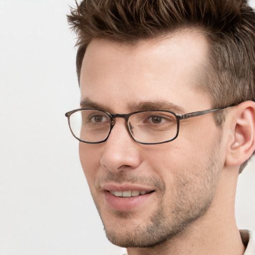 Joyful white adult male with short  brown hair and grey eyes